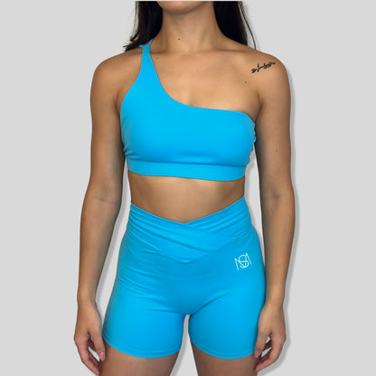 Conjunto de ginástica azul claro com um ombro inclinado